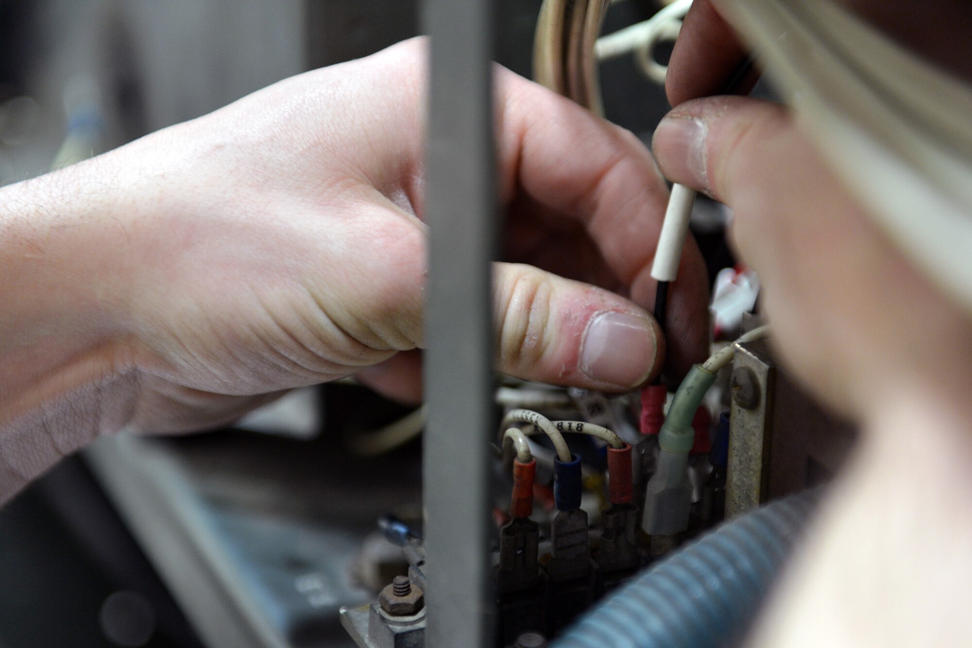 Senior Airman Mathew Vanderwater, 62nd Maintenance Squadron Aerospace Ground Equipment technician, reconnects wires to a terminal board during a change out of a faulty wiring harness on a -86 diesel generator, April 26, 2013 at Joint Base Lewis-McChord, Wash. AGE technicians are trained in a wide variety of maintenance disciplines, to include electrical theory, diesel and turbine engine maintenance, and hydraulic systems. (U.S. Air Force photo/Airman 1st Class Jacob Jimenez)