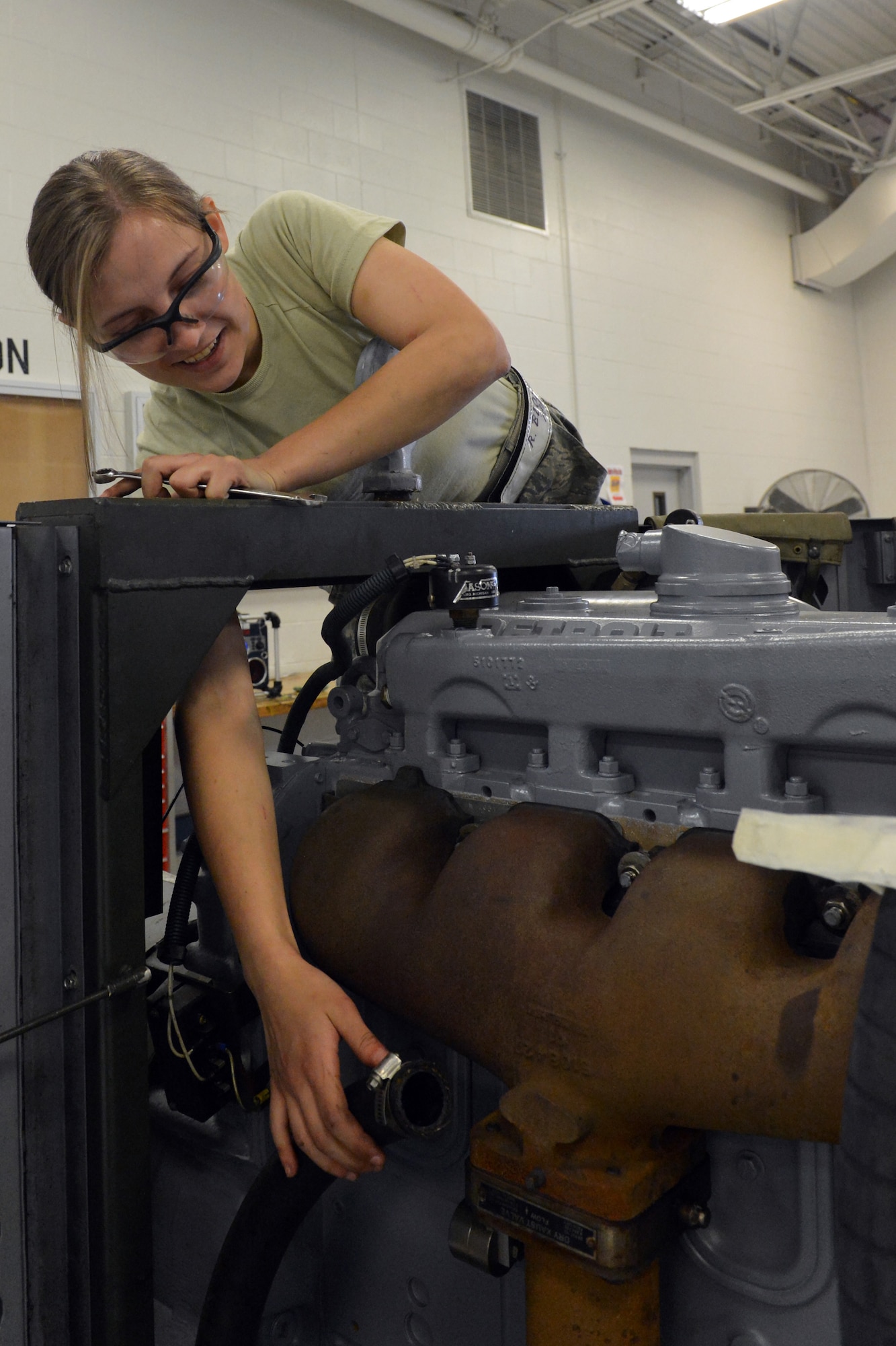 Airman 1st Class Rebecca Blossom, 62nd Maintenance Squadron Aerospace Ground Equipment technician, removes a water hose from a -86 diesel generator during an engine replacement, April 25, 2013 at Joint Base Lewis-McChord, Wash. AGE consists of a variety of support equipment, to include various generators, light carts, mobile air conditioners and heaters, as well as bomblifts used for loading ordnance on aircraft. (U.S. Air Force photo/Airman 1st Class Jacob Jimenez)