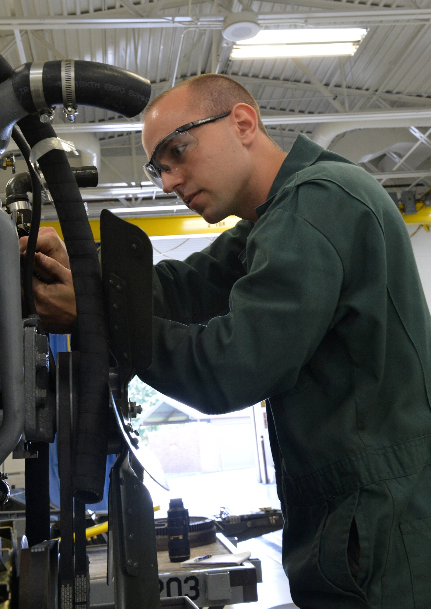 Airman 1st Class Jared Williams, 62nd Maintenance Squadron Aerospace Ground Equipment technician, tightens bolts on a -86 diesel generator after swapping out its engine, April 25, 2013 at Joint Base Lewis-McChord, Wash. Williams performs regular maintenance and inspections to Team McChord’s AGE. (U.S. Air Force photo/Airman 1st Class Jacob Jimenez)  