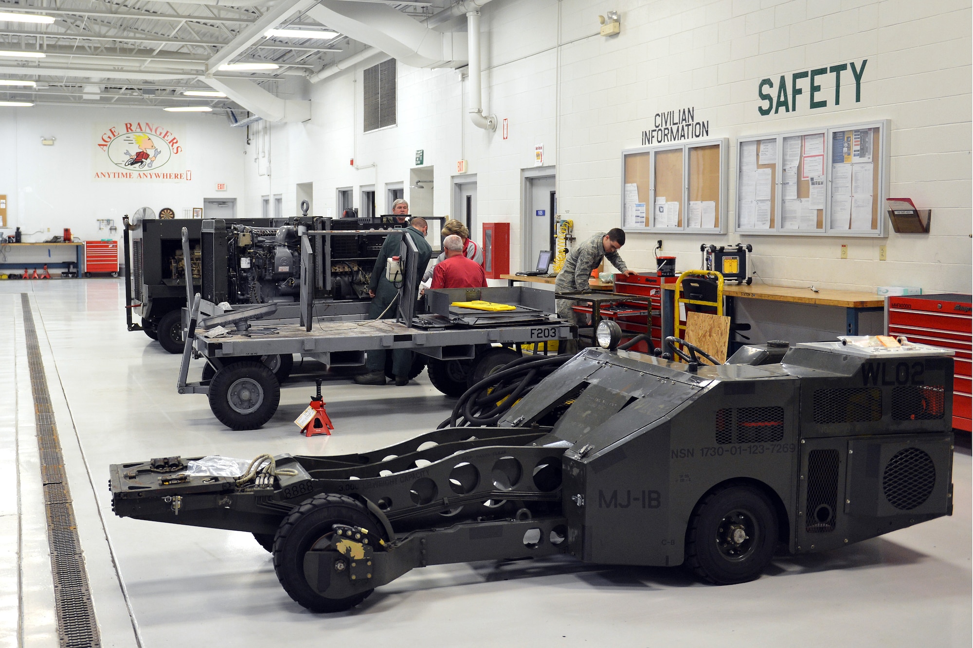 Technicians from the 62nd Maintenance Squadron Aerospace Ground Equipment Flight repair and inspect AGE equipment, April 26, 2013 at Joint Base Lewis-McChord, Wash. The AGE Flight is responsible for maintaining support equipment used for servicing aircraft while on the ground. (U.S. Air Force photo/Airman 1st Class Jacob Jimenez)