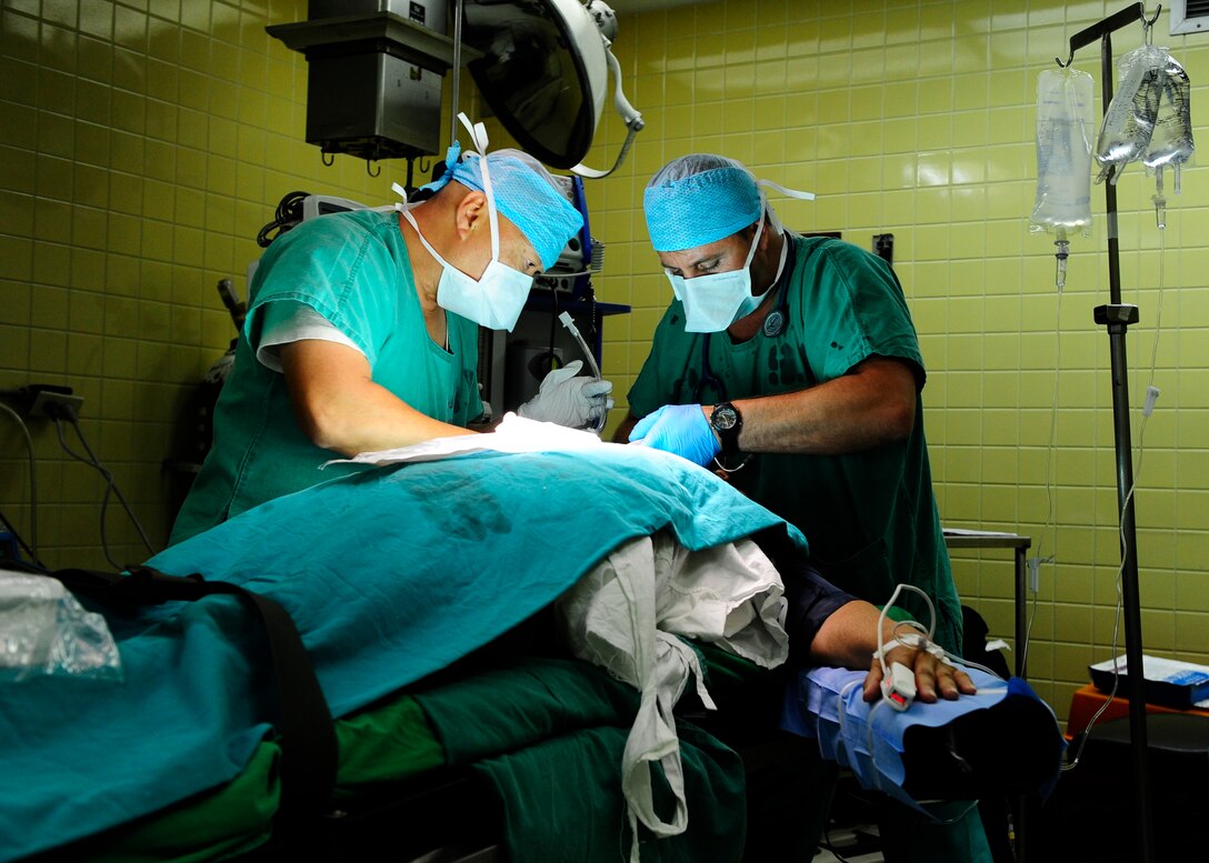 Army Capt. William Ang Abrigo, Medical Surgical Team surgical nurse and Army Capt. Shawn Fahey, MST nurse anesthetist, prepare a patient for surgery at Hospital Escuela, Tegucigalpa, during a surgical Medical Readiness Exercise, April 23. The MST conducts surgical MEDRETEs in Tegucigalpa once a month.(Air Force photo by Staff Sgt. Eric Donner)