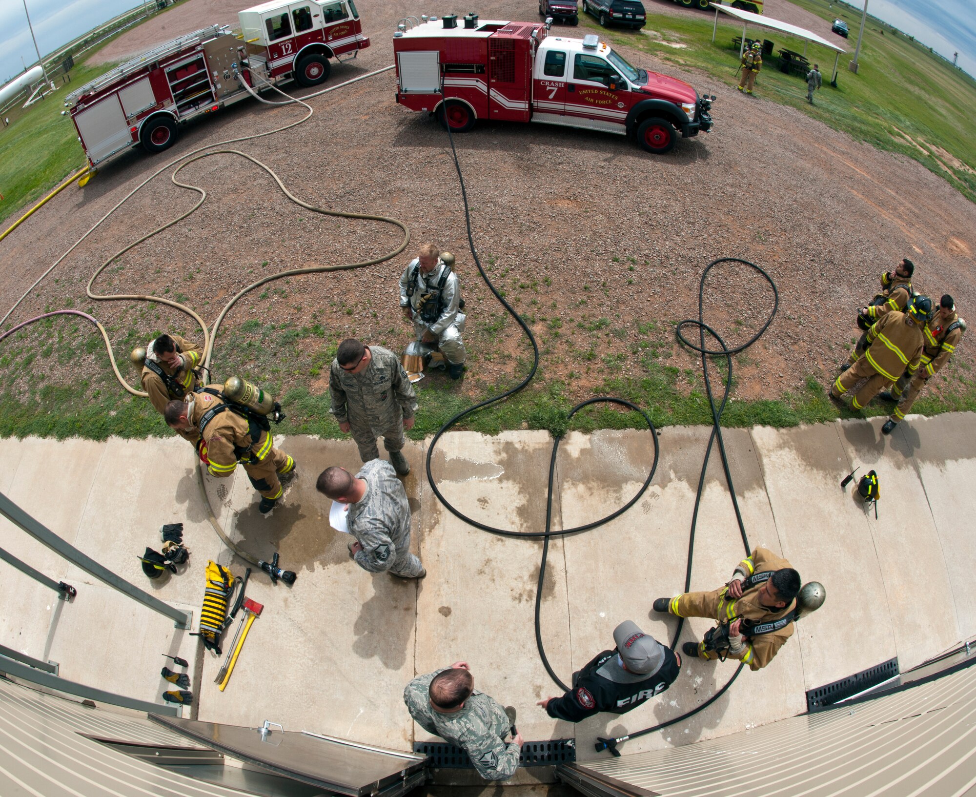 ALTUS AIR FORCE BASE, Okla. - Firefighters from the 97th Civil Engineer Squadron Fire Department prepare to conduct training using a new Ultra High Pressure system at the burn pit, April 25. Members of the 97th CES Fire Department trained with the new P-34 Rapid Intervention Vehicle, which is the newest addition to the Air Force’s crash response fleet and the first vehicle to use Ultra High Pressure firefighting technology. (U.S. Air Force photo by Senior Airman Kenneth W. Norman))