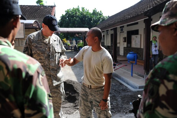 U.S. Air Force Staff Sgt. Endro Accettola, an electrical systems journeyman, talks to Tech. Sgt. John Graham, site three lead, during Pacific Angel 13-2 at Yogyakarta, Indonesia, April 25, 2013. PACANGEL is a joint and combined humanitarian assistance exercise held in various countries several times a year and includes medical, dental, optometry, engineering programs and various subject-matter expert exchanges. (U.S. Air Force photo by Airman 1st Class Kia Atkins)