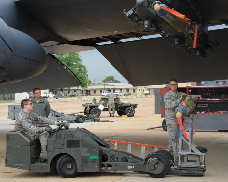 Airmen from the 2nd Aircraft Maintenance Squadron weapons load team install a Guided Bomb Unit-12 during a weapon's load competition on Barksdale Air Force Base, La., April 26, 2013. The quarterly competition is performed to determine the best load team on Barksdale. The teams are graded on dress and appearance, a written test, a tool box inspection and the weapons load process. (U.S. Air Force photo/Senior Airman Sean Martin)