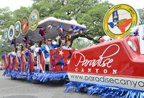 The 2013 Military Ambassadors for Joint Base San Antonio took part in the Battle of Flowers Parade as part of the Fiesta celebration activities April 26, at the Alamo Plaza San Antonio Texas. (U.S. Air Force photo by Benjamin Faske) (released)