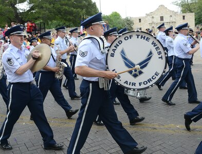 The U.S. Air Force Band of the West, marched in the 2013 Battle of Flowers Parade as part of the Fiesta celebration April 26, at the Alamo Plaza San Antonio Texas. (U.S. Air Force photo by Benjamin Faske) (released)
