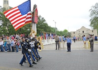 The color guard marches down Alamo St. to kick off the Battle of Flowers Parade during the Fiesta celebration April 26, at the Alamo Plaza San Antonio Texas. (U.S. Air Force photo by Benjamin Faske) (released)