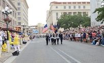 The color guard marches down Alamo St. to kick off the Battle of Flowers Parade during the Fiesta celebration April 26, at the Alamo Plaza San Antonio Texas. (U.S. Air Force photo by Benjamin Faske) (released)