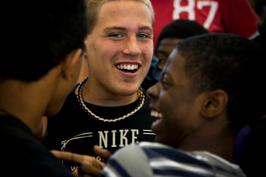 Ian Lamp, son of U.S. Air Force Master Sgt. John Lamp, 23d Component Maintenance Squadron first sergeant, receives support and congratulations from fellow students after cutting his hair for Locks of Love April 26, 2013, at Pine Grove Middle School, Valdosta, Ga. Known for his long hair and playing football, Lamp was nicknamed Baby Clay Matthews in school after the National Football League pro athlete. (U.S. Air Force photo by Staff Sgt. Jamal D. Sutter/Released) 