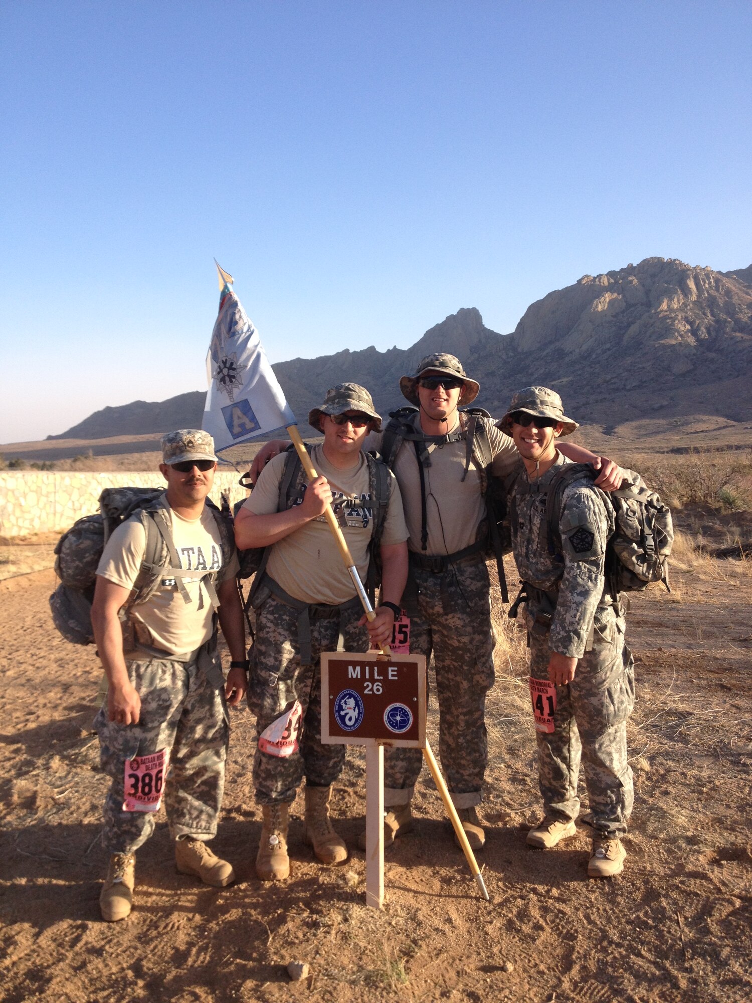 Capt. William Denn III, commander of Alpha Company, 743rd Military Intelligence Battalion, 704th MI Brigade, right, poses with his team during the 2013 Bataan Memorial Death March while deployed. Denn is the recipient of the General MacArthur Leadership Award. (U.S. Army courtesy photo)
