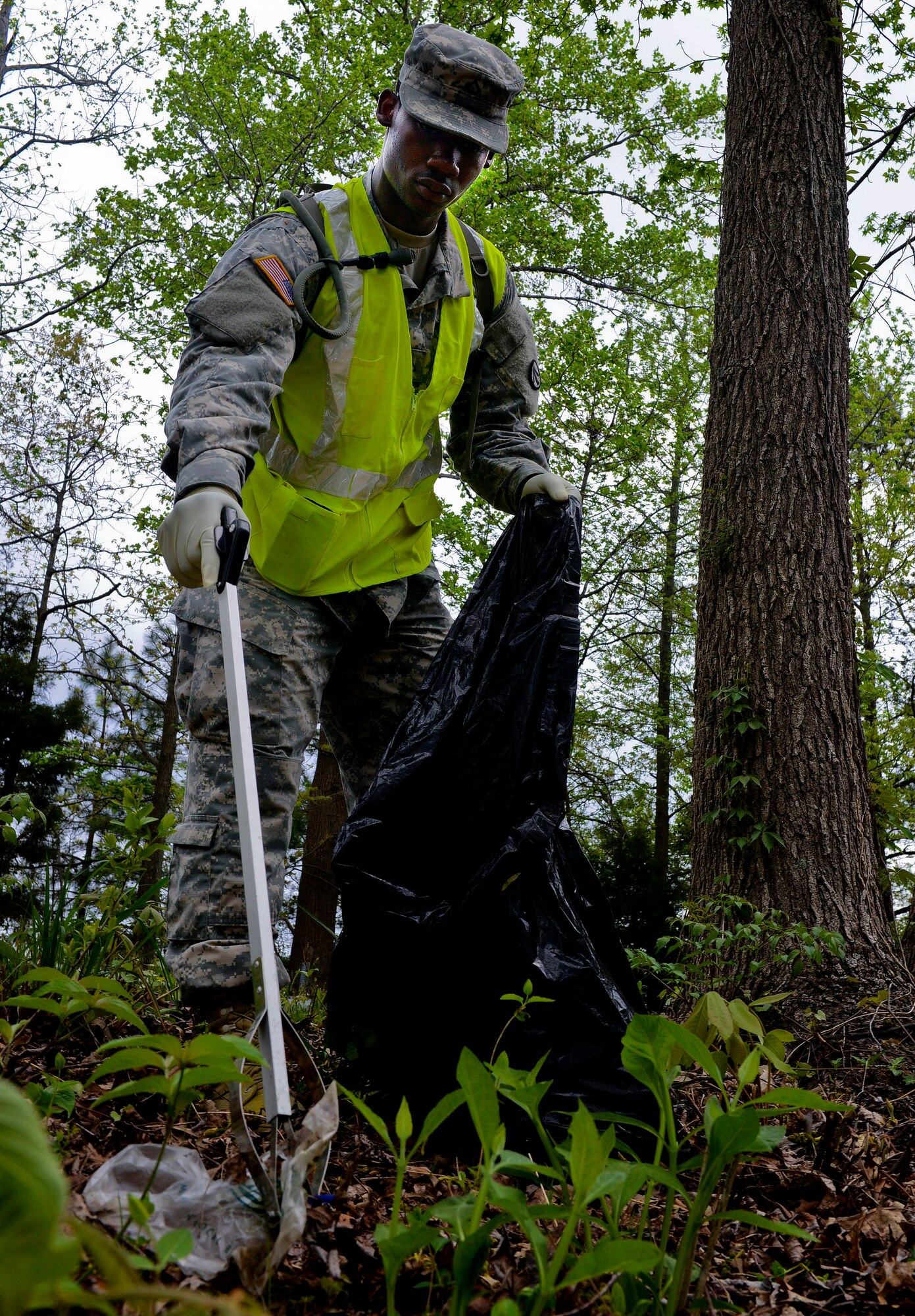 U.S. Army Pfc. Marqis Talbot, 689th Rapid Port Opening Element cargo specialist, picks up garbage in the unit’s “Adopt-a-Spot” project in Newport News, Va., April 19, 2013. In addition to the cleanup project, the 689th RPOE plans to assist the Newport News Public Schools special education program host their field day later this month, and routinely visits local elementary and middle schools for field and career days.  (U.S. Air Force photo by Airman 1st Class R. Alex Durbin/Released)

