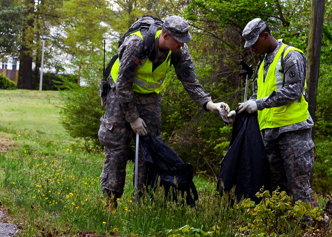 U.S. Army Sgt. Ronald Taylor, 689th Rapid Port Open Element communications noncommissioned officer in charge, and Pfc. Marqis Talbot, 689th RPOE cargo specialist, participate in the unit’s “Adopt-a-Spot” project in Newport News, Va., April 19, 2013. First Lt. Brian Kavanagh, the unit's clearance platoon leader, organized the clean-up event to give his Soldiers an opportunity to support the local community. (U.S. Air Force photo by Airman 1st Class R. Alex Durbin/Released)