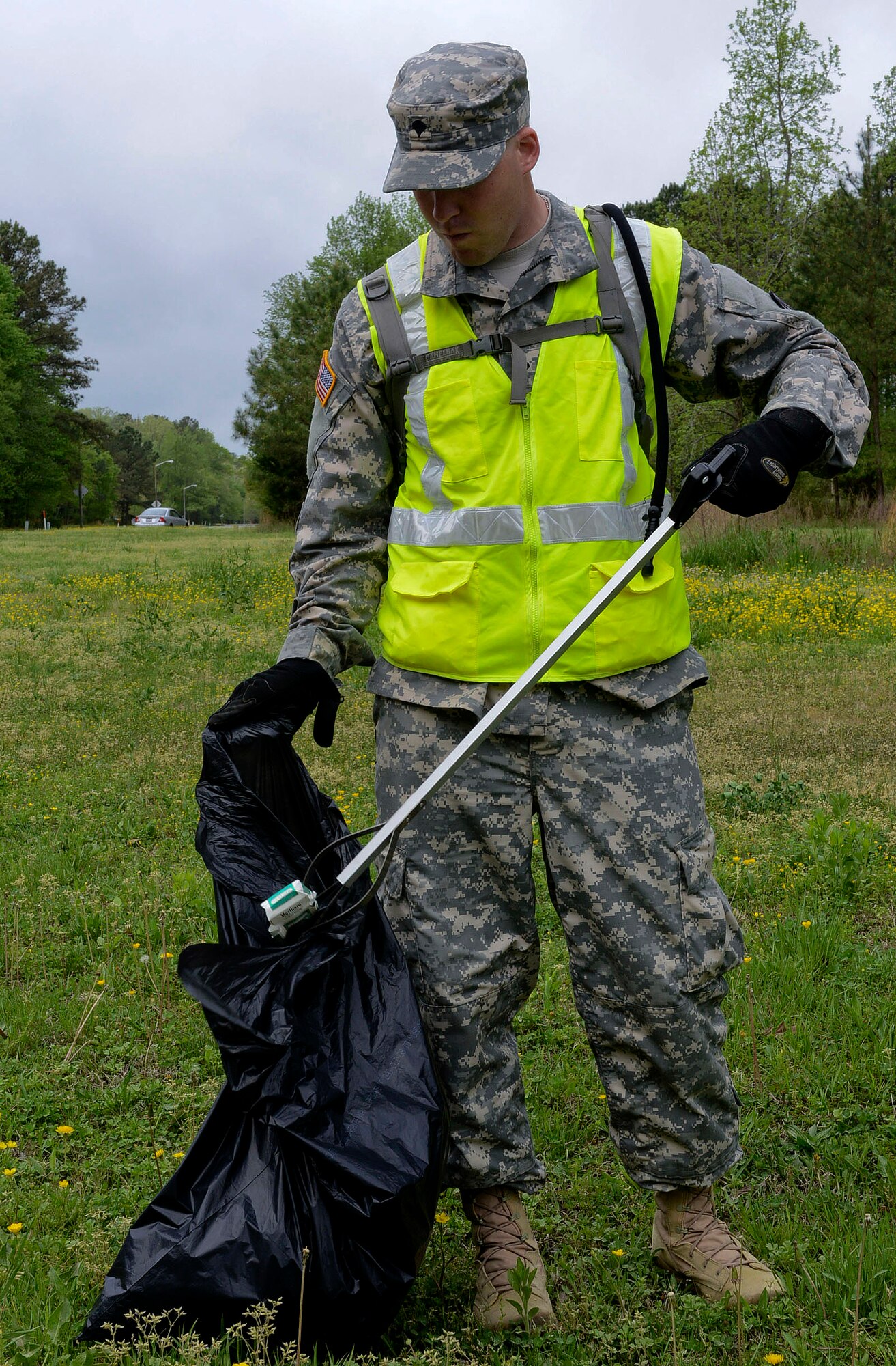 U.S. Army Spc. Carl Gahry, 689th Rapid Port Opening Element transportation management coordinator, participates in the unit’s “Adopt-a-Spot” project in Newport News, Va., April 19, 2013. Gahry was one of 25 Soldiers picking up garbage along a three-mile stretch of the roadway. (U.S. Air Force photo by Airman 1st Class R. Alex Durbin/Released)