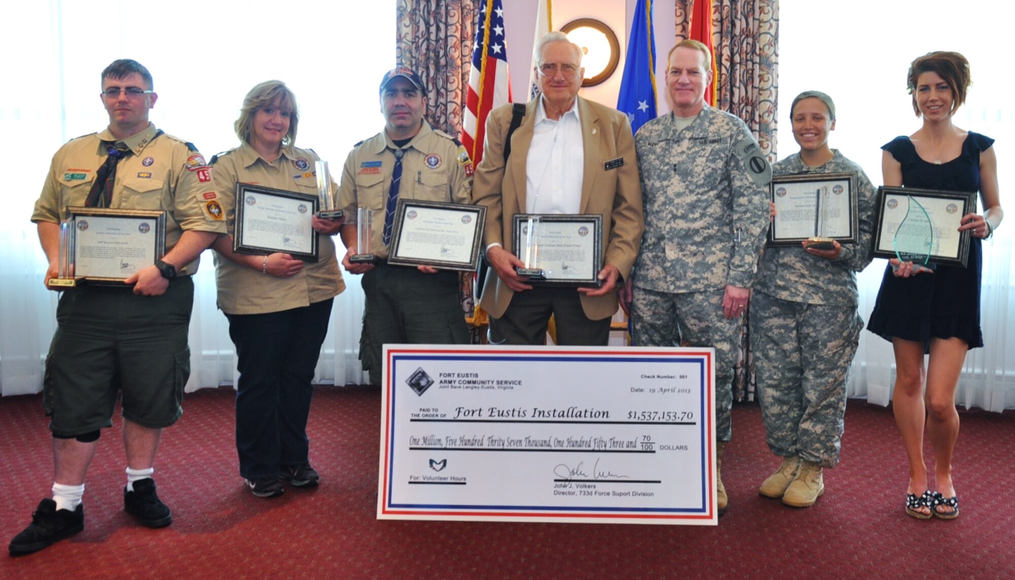 The Fort Eustis 2013 Volunteers of the Year showcase their awards during the annual Volunteer Recognition ceremony at the Fort Eustis Club on Fort Eustis, Va., April 19, 2013. Pictured, from left: Staff Sgt. Ricky Butler, Soldier Volunteer of the Year; Barbara Perez, Volunteer Family Member of the Year;  Sgt. 1st Class Jesus Perez, representing his family for Volunteer Family of the Year; Retired Lt. Col. Robert Price, Retiree Volunteer of the Year;  Maj. Gen. Bradley May, the senior commander of Army Element Eustis and deputy commanding general of Initial Military Training; Spc. Taylor Hermansen, Single Soldier Volunteer of the Year; and Carissa Burgett, Command Sgt. Maj. David E. Minor Volunteer of the Year. (U.S. Air Force photo by Senior Airman Jason J. Brown/Released)
