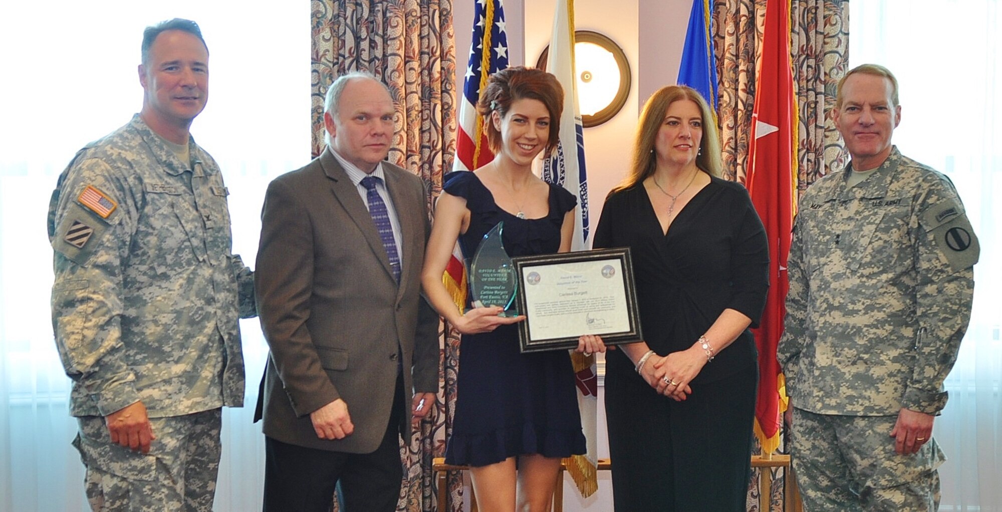 Carissa Burgett (center), receives the 2013 Command Sgt. Maj. David E. Minor Volunteer of the Year award during the annual Volunteer Recognition ceremony at the Fort Eustis Club on Fort Eustis, Va., April 19, 2013. Pictured with Burgett are, from right: Maj. Gen. Bradley May, senior commander of Army Element Eustis and deputy commanding general of Initial Military Training; Deborah Parker, Minor's daughter and her husband, James Parker; and Col. Thomas Wetherington, the 733rd Mission Support Group commander. (U.S. Air Force photo by Senior Airman Jason J. Brown/Released)