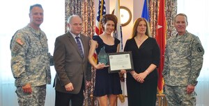 Carissa Burgett (center), receives the 2013 Command Sgt. Maj. David E. Minor Volunteer of the Year award during the annual Volunteer Recognition ceremony at the Fort Eustis Club on Fort Eustis, Va., April 19, 2013. Pictured with Burgett are, from right: Maj. Gen. Bradley May, senior commander of Army Element Eustis and deputy commanding general of Initial Military Training; Deborah Parker, Minor's daughter and her husband, James Parker; and Col. Thomas Wetherington, the 733rd Mission Support Group commander. (U.S. Air Force photo by Senior Airman Jason J. Brown/Released)