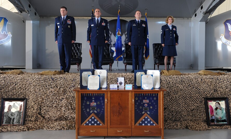 U.S. Air Force Chief Master Sgts. Dianna Vallely (far right), 23d Medical Group chief enlisted manager, and Thomas Vallely (second from left), former 93rd Air Ground Operations Wing command chief master sergeant, stand on stage during their retirement ceremony at Moody Air Force Base, Ga., April 26, 2013. The Vallelys were both recognized for their outstanding work while in service. (U.S. Air Force photo by Airman Alexis Grotz/Released)