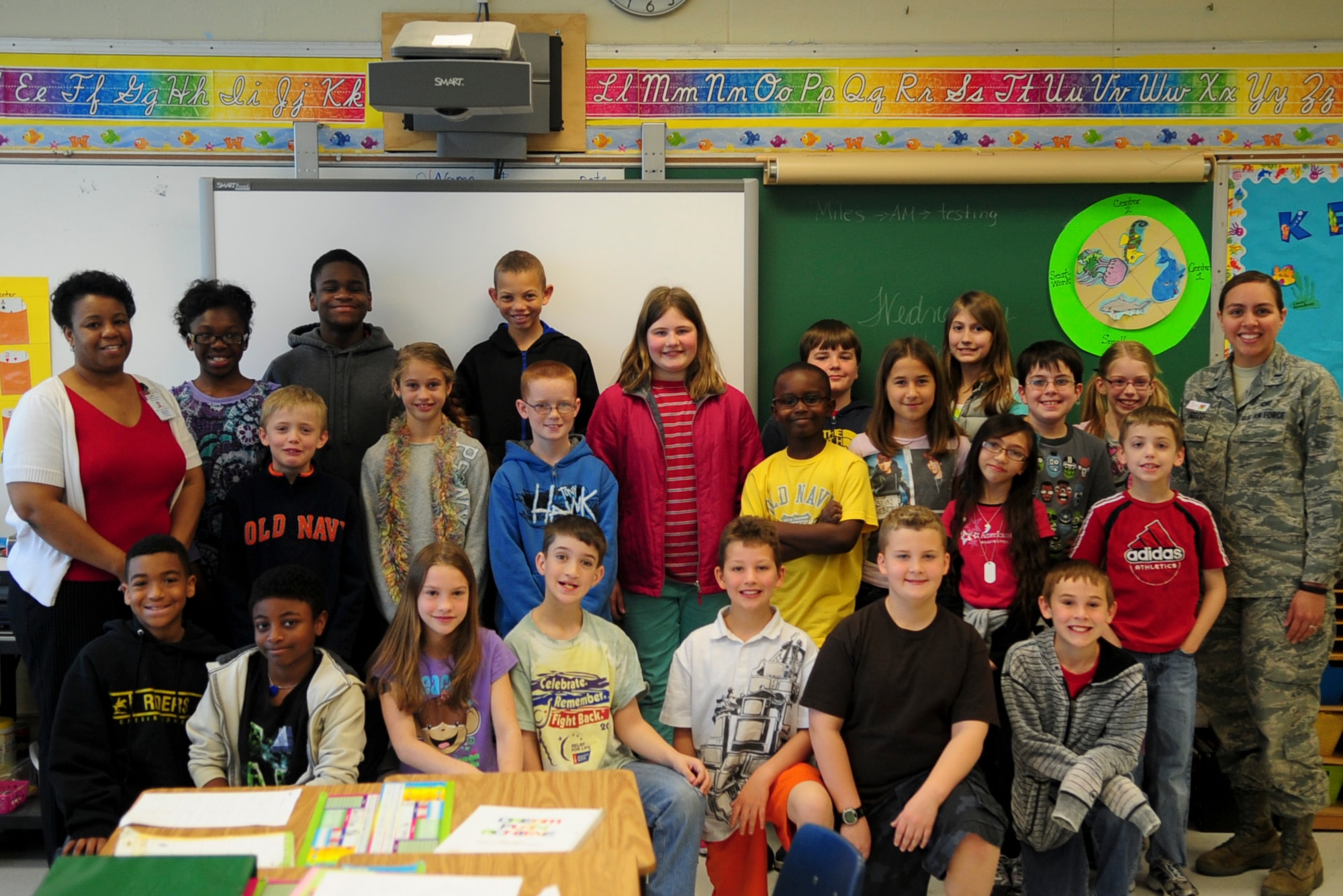 1st Lt. Jennifer Bosco, 436 Airlift Wing Public Affairs deputy chief, poses with students she taught as part of the junior achievement program at the Major George S.Welch elementary school Dover Air Force Base, Del. Apr. 25, 2013. Bosco voluntarily taught junior achievement for 6 weeks to help educate students about workforce readiness and entrepreneurship. (U.S. Air Force photo/Senior Airman Jared Duhon)
