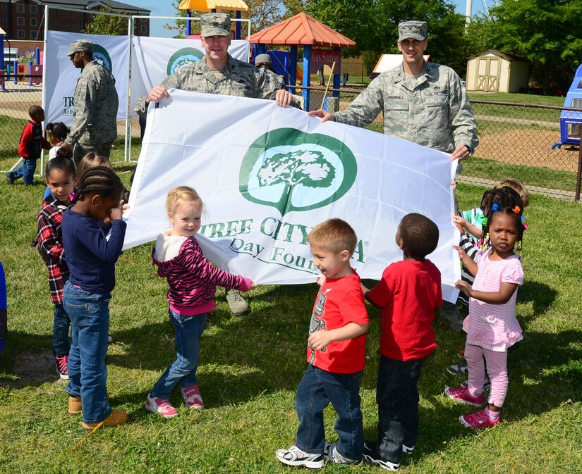 U.S. Air Force Col. John J. Allen Jr., 633rd Air Base Wing commander, and Col. David Chisenhall, 633rd Mission Support Group commander, pose for a picture with children from the Langley Child Development Center at Langley Air Force Base, Va., April 25, 2013. The tree planting ceremony was part of a week-long Earth Week celebration at Langley.  (U.S. Air Force photo by Senior Airman Kayla Newman/Released)