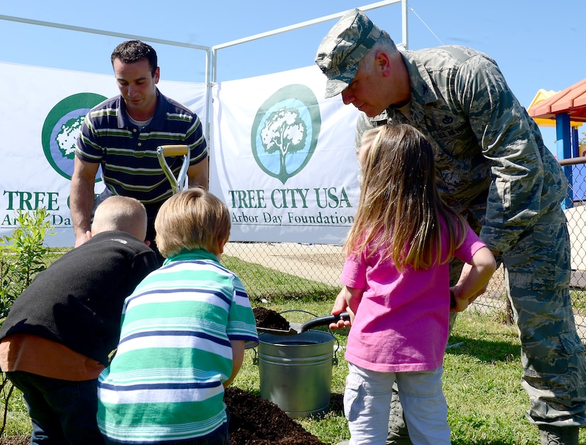 U.S. Air Force Col. John J. Allen Jr., 633rd Air Base Wing commander, helps children from the Langley Child Development Center plant a tree to celebrate Earth Day and Arbor Day at Langley Air Force Base, Va., April 25, 2013. The tree planting ceremony was one of several events that took place to celebrate Earth Day. (U.S. Air Force photo by Senior Airman Kayla Newman/Released)