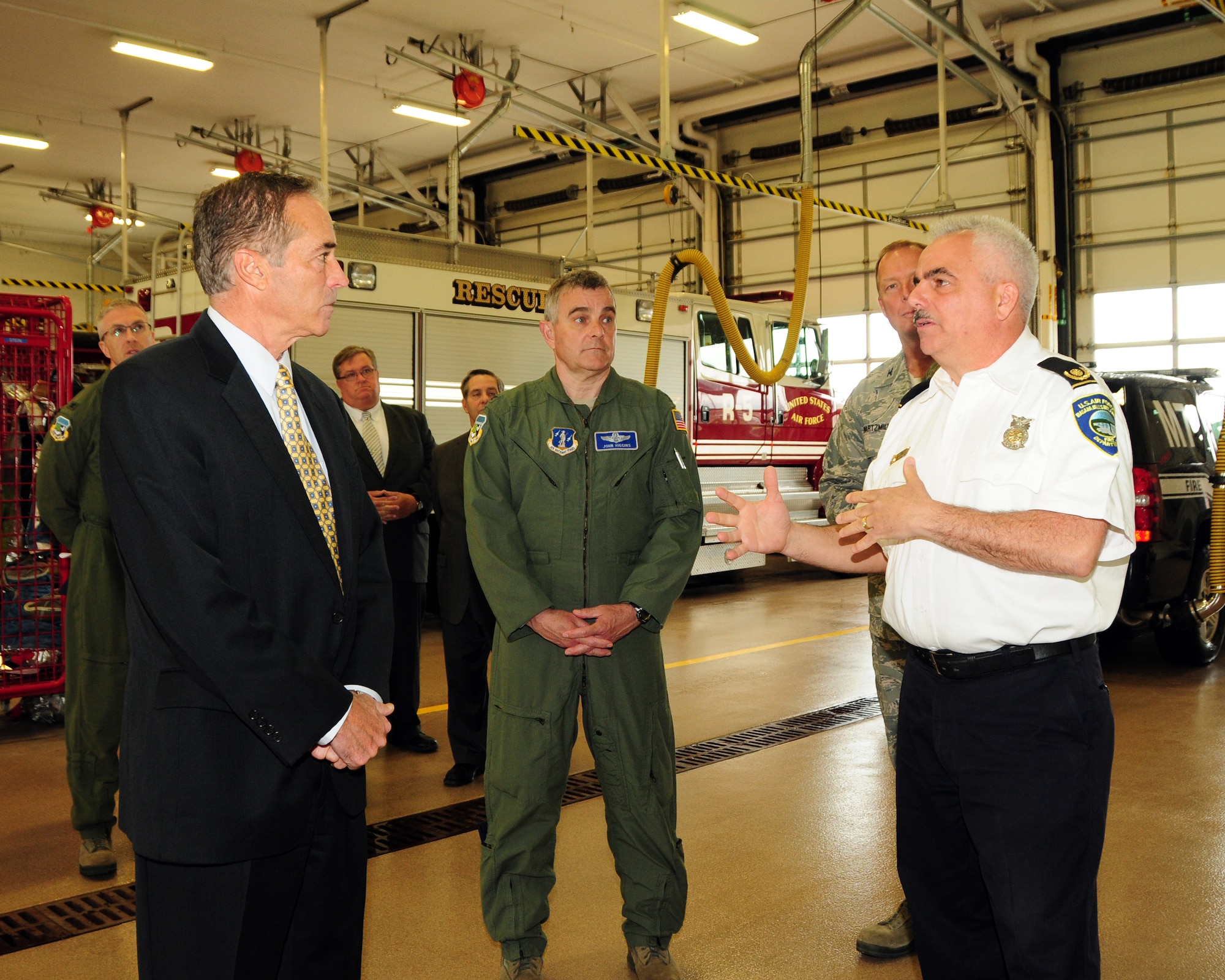 Congressman Chris Collins (NY-27) is being briefed by Ed MacDonald (far right), Fire Chief, Niagara Falls Air Reserve Station Fire Department while Col. John Higgins (center) Commander, 107th Airlift Wing and others look on here at the base on April 29, 2013. The Congressman was on hand for an official fact finding tour of the units and its facilities at the base. (U.S. Air Force Reserve photo by Peter Borys)