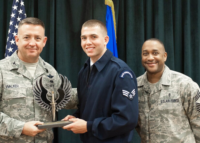 Colonel Craig Walker 27th Special Operations Wing Vice Commander, along with Chief Master Sergeant Marvin Neely present Senior Airman Brady Palmer with the 2013 Honor Guardsman of the Quarter award for first quarter April 26. Winners were selected based on outstanding accomplishments during the months of January through March. (U.S. Air Force photo/ Airman 1st Class Xavier Lockley)