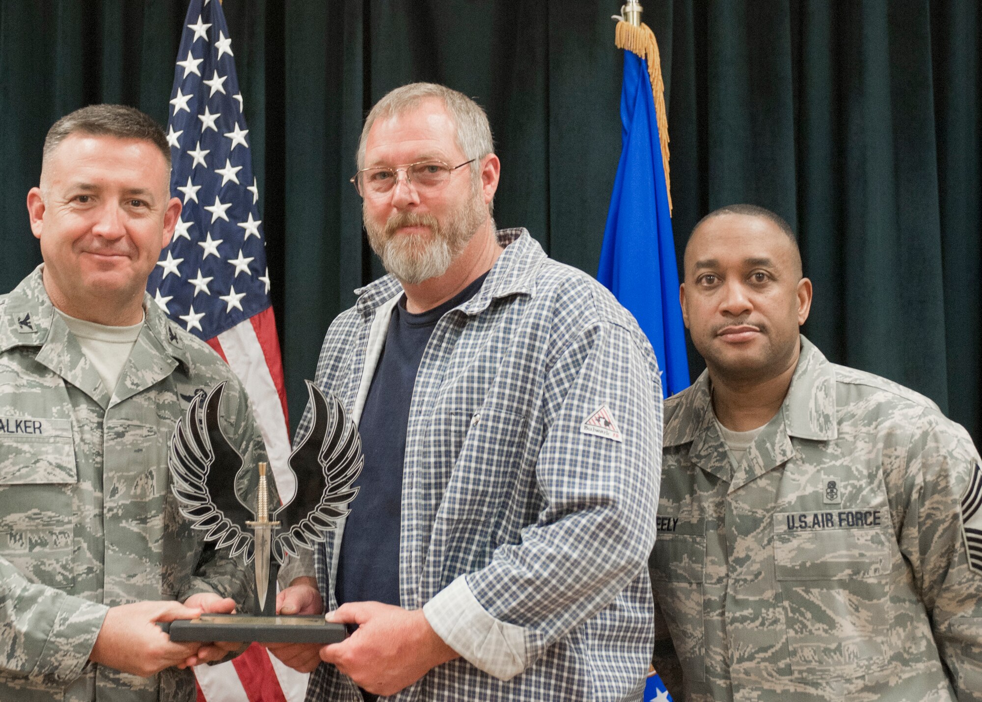 Colonel Craig Walker 27th Special Operations Wing Vice Commander, along with Chief Master Sergeant Marvin Neely present Mr. Jon Bonifant with the 2013 Civilian category III of the Quarter award for first quarter April 26. Winners were selected based on outstanding accomplishments during the months of January through March. (U.S. Air Force photo/ Airman 1st Class Xavier Lockley)