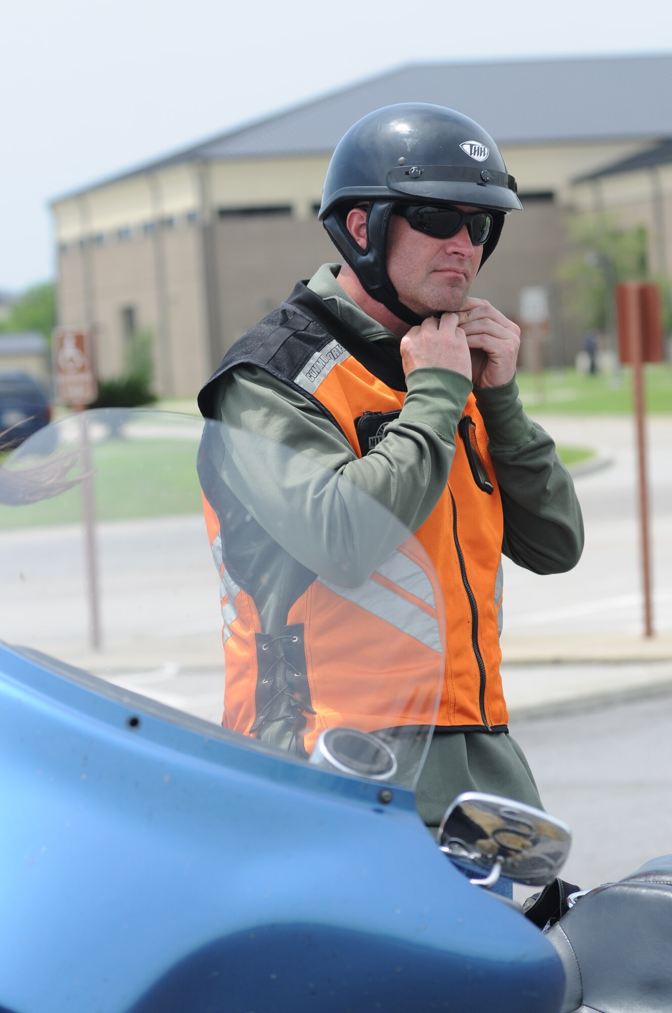 Tech. Sgt. Jason Sharp, 403rd Maintenance Squadron, fastens his helmet strap before boarding his motorcycle during motorcycle safety training April 18, 2013, at Keesler Air Force Base, Miss.  The course is offered two times a month and teaches students the basic operating skills and safety rules for riding a motorcycle on the road.  (U.S. Air Force photo by Kemberly Groue)