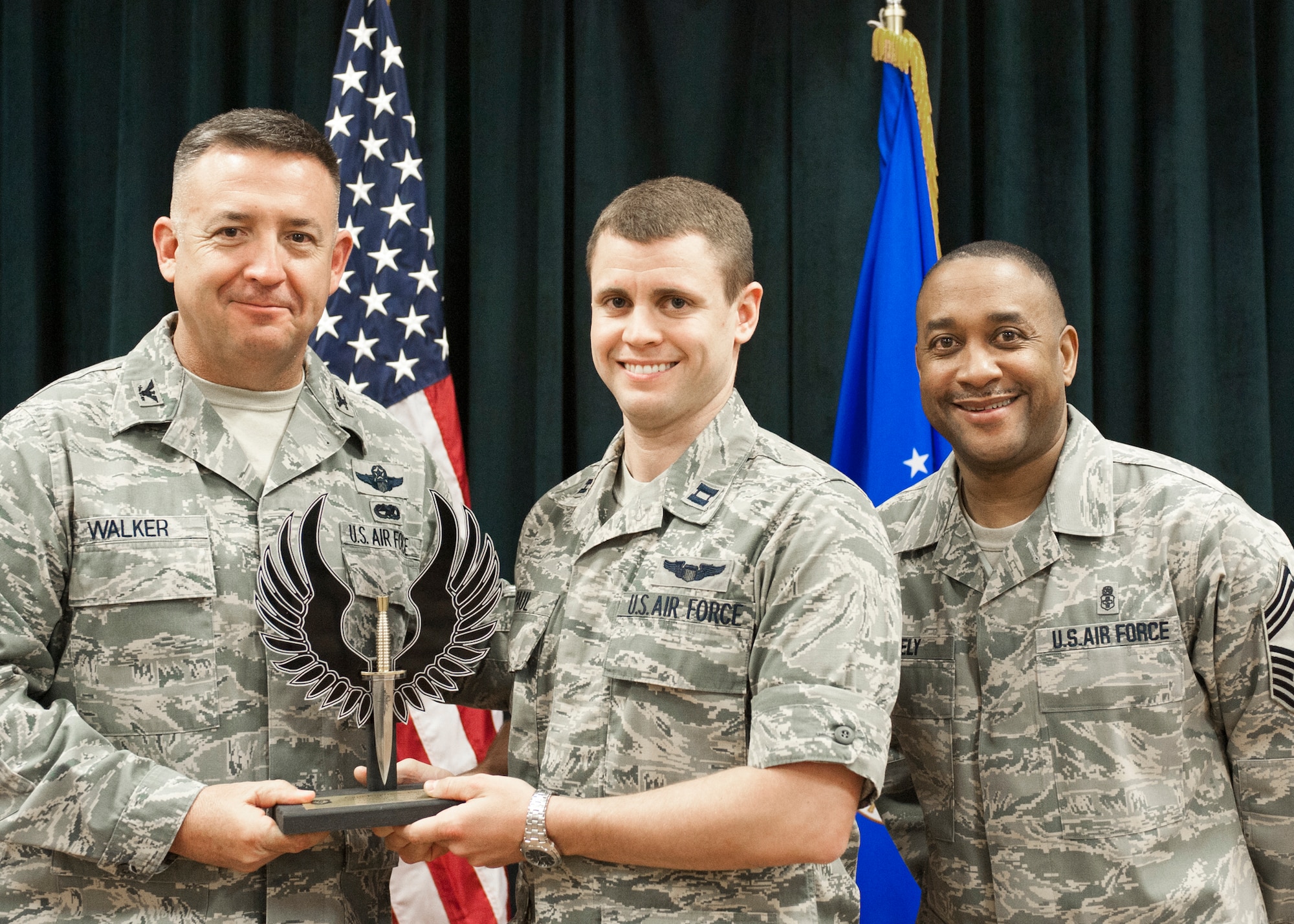 Colonel Craig Walker 27th Special Operations Wing Vice Commander, along with Chief Master Sergeant Marvin Neely present Capt. Kurtis Paul with the 2013 CGO of the Quarter award for first quarter April 26. Winners were selected based on outstanding accomplishments during the months of January through March. (U.S. Air Force photo/ Airman 1st Class Xavier Lockley)