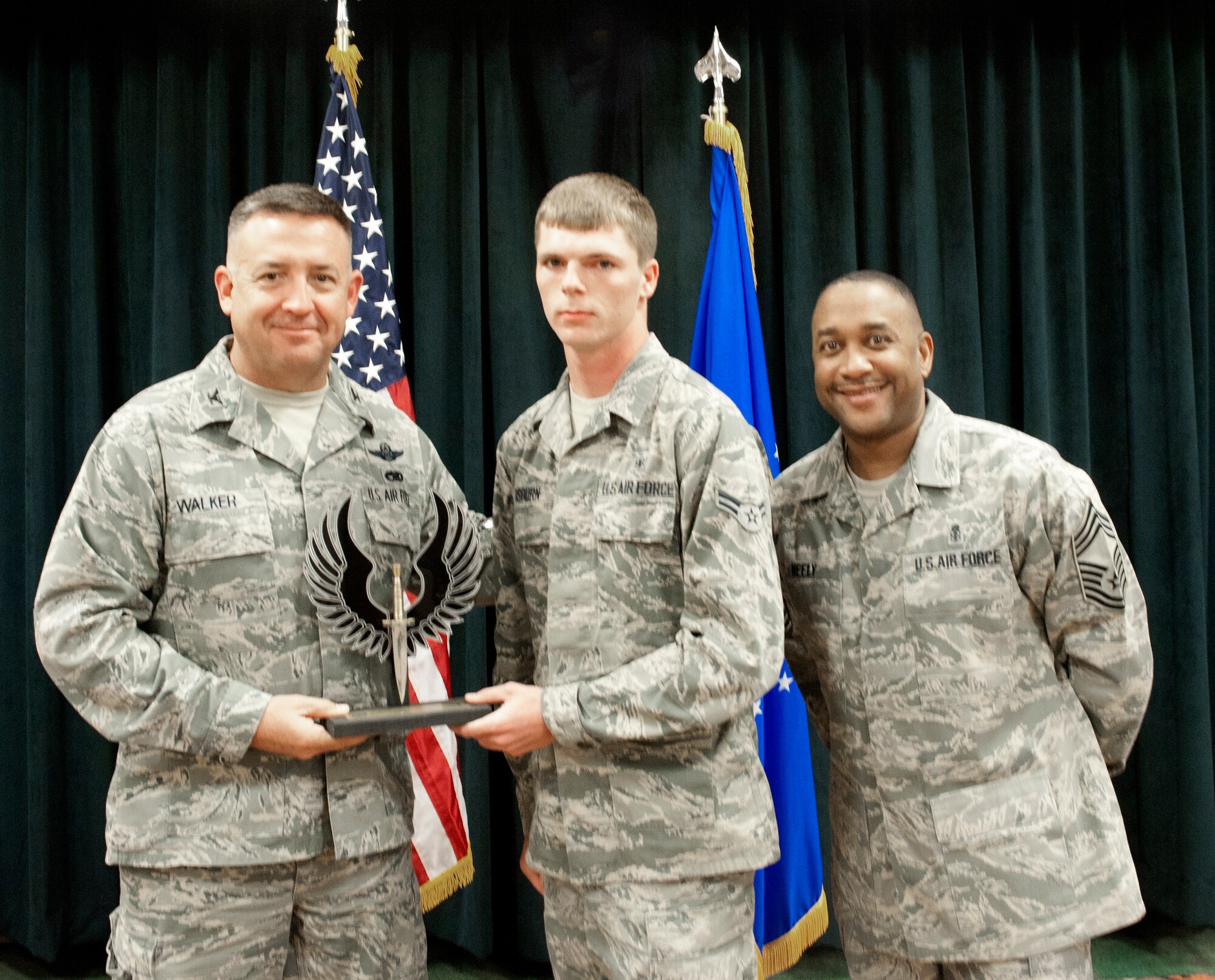 Colonel Craig Walker 27th Special Operations Wing Vice Commander, along with Chief Master Sergeant Marvin Neely present Airman 1st Class David Osburn with the 2013 Airman of the Quarter award for first quarter April 26. Winners were selected based on outstanding accomplishments during the months of January through March. (U.S. Air Force photo/ Airman 1st Class Xavier Lockley)