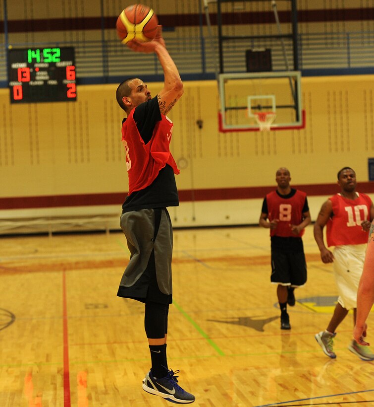 Senior Airman Rawlinson Santaella, 28th Maintenance Squadron crew chief, shoots from beyond the three-point line during the base 2013 Intramural Basketball League championship game in the Bellamy Fitness Center at Ellsworth Air Force Base, S.D., April 24, 2013. During the final game, the culmination of two months of heated competition, the 28th SFS squared off against their rivals, the 28th Aircraft Maintenance Squadron, and netted a 79-62 hard-fought victory. (U.S. Air Force photo by Airman 1st Class Hrair H. Palyan/Released)