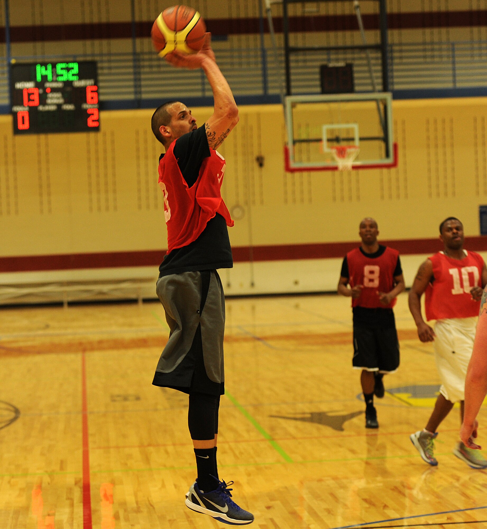 Senior Airman Rawlinson Santaella, 28th Maintenance Squadron crew chief, shoots from beyond the three-point line during the base 2013 Intramural Basketball League championship game in the Bellamy Fitness Center at Ellsworth Air Force Base, S.D., April 24, 2013. During the final game, the culmination of two months of heated competition, the 28th SFS squared off against their rivals, the 28th Aircraft Maintenance Squadron, and netted a 79-62 hard-fought victory. (U.S. Air Force photo by Airman 1st Class Hrair H. Palyan/Released)