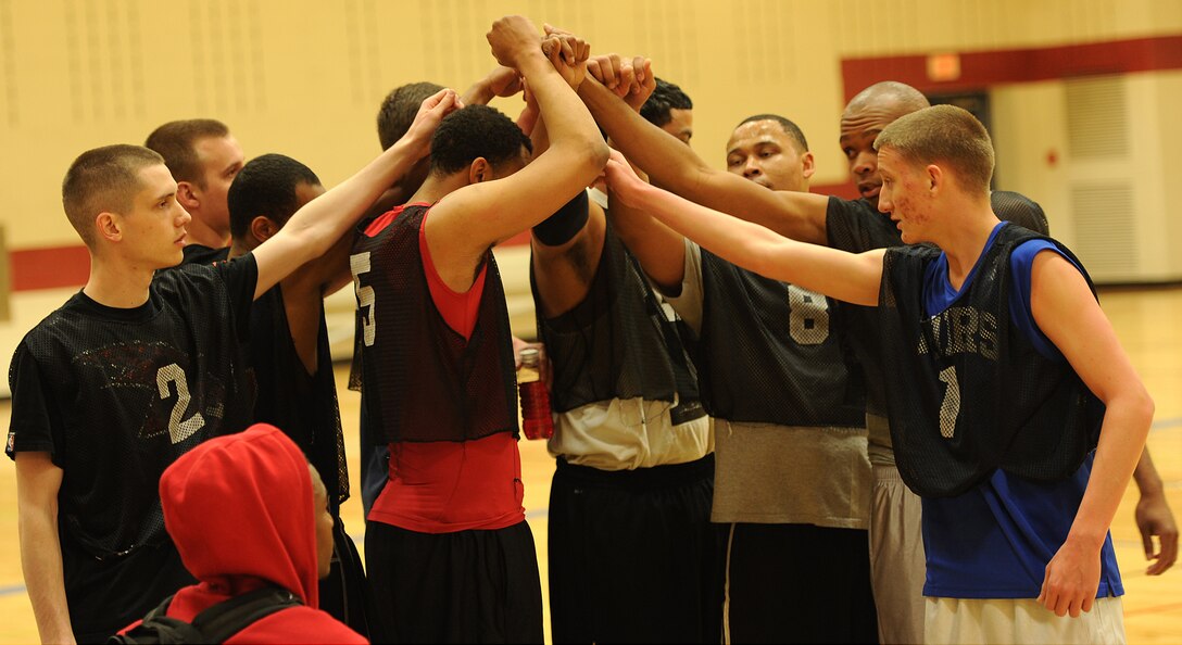 Players from the 28th Aircraft Maintenance Squadron huddle together during halftime of the base 2013 Intramural Basketball League championship game in the Bellamy Fitness Center at Ellsworth Air Force Base, S.D., April 24, 2013. The 28th Security Forces Squadron claimed the basketball crown following a heated battle against the 28th AMXS, 79-62. (U.S. Air Force photo by Airman 1st Class Hrair H. Palyan/Released)