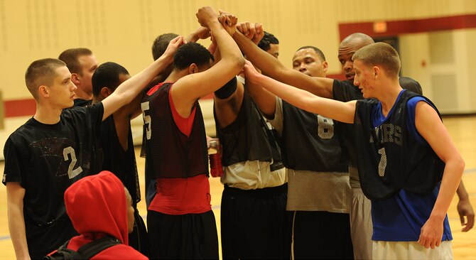 Players from the 28th Aircraft Maintenance Squadron huddle together during halftime of the base 2013 Intramural Basketball League championship game in the Bellamy Fitness Center at Ellsworth Air Force Base, S.D., April 24, 2013. The 28th Security Forces Squadron claimed the basketball crown following a heated battle against the 28th AMXS, 79-62. (U.S. Air Force photo by Airman 1st Class Hrair H. Palyan/Released)