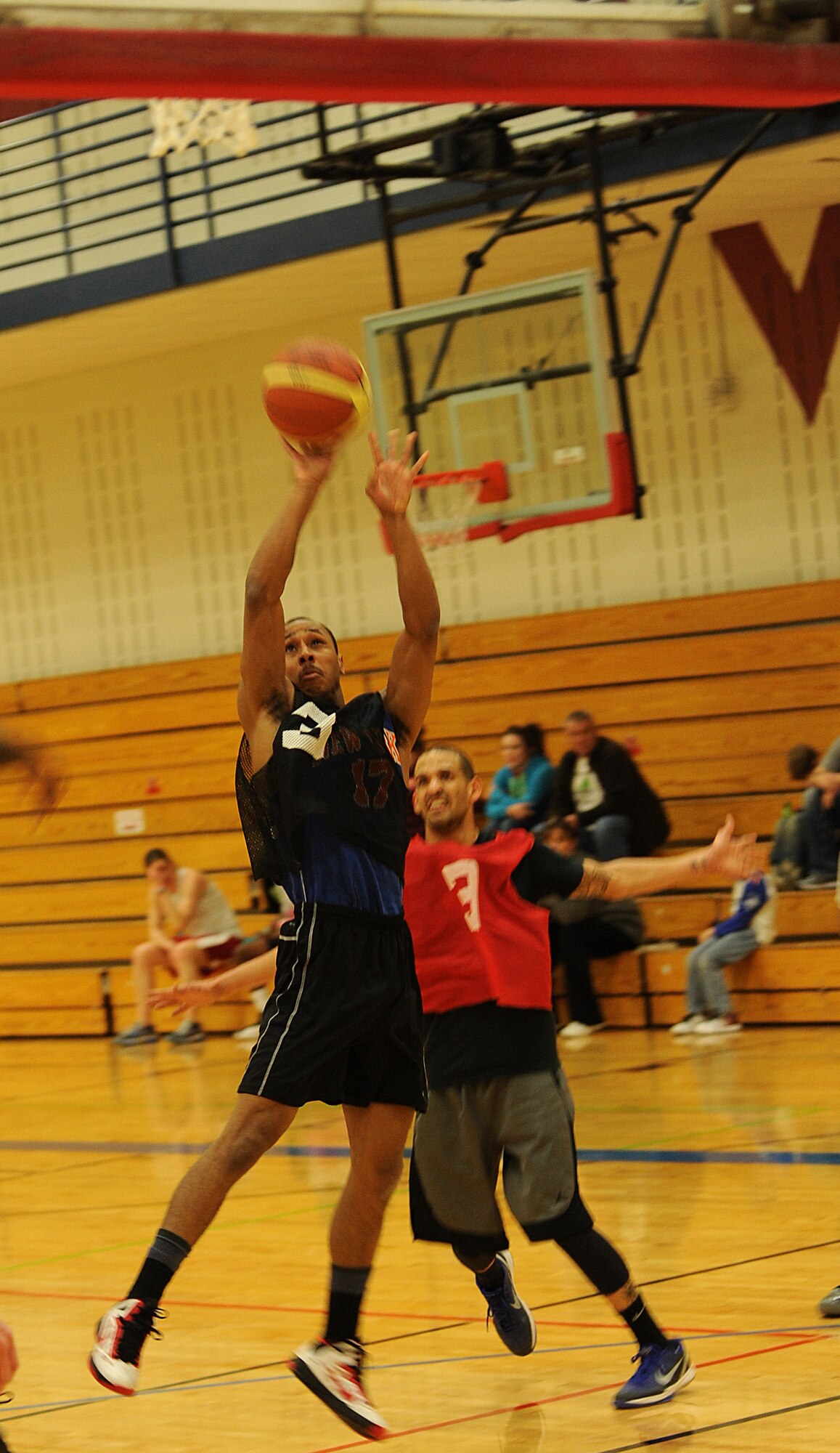 Airman 1st Class Michael Bryant, 28th Aircraft Maintenance Squadron weapons loader, takes a jump shot during the base 2013 Intramural Basketball League championship game in the Bellamy Fitness Center at Ellsworth Air Force Base, S.D., April 24, 2013. During April, all 10 teams in the league faced off against each other in the playoffs, and the 28th AMXS and 28th Security Forces Squadron emerged as the two teams competing in the final game. (U.S. Air Force photo by Airman 1st Class Hrair H. Palyan/Released)