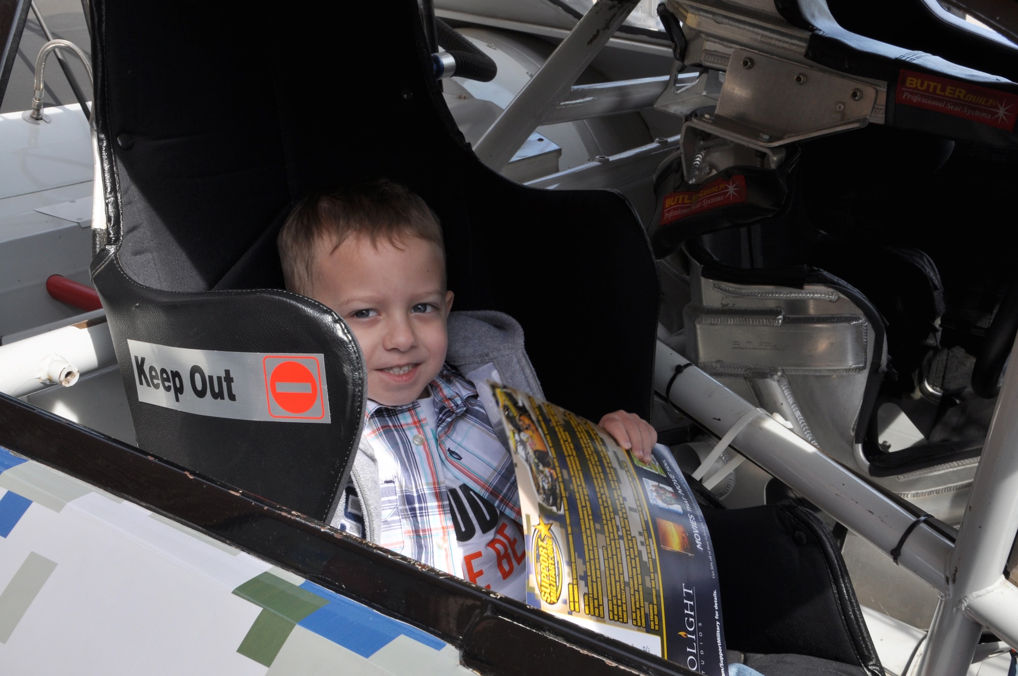 Westyn, son of Staff Sgt. Matthew Williamson, 597th Transportation Brigade human resources noncommissioned officer, learns what it’s like to be inside of a NASCAR show car at Fort Eustis, Va., April 4, 2013. In addition to the car, Dell Hamilton, owner of the Hamilton Means Racing Team, was on hand to thank service personnel for their service and sign autographs. (U.S. Air Force photo by Tech. Sgt. April Wickes/Released)