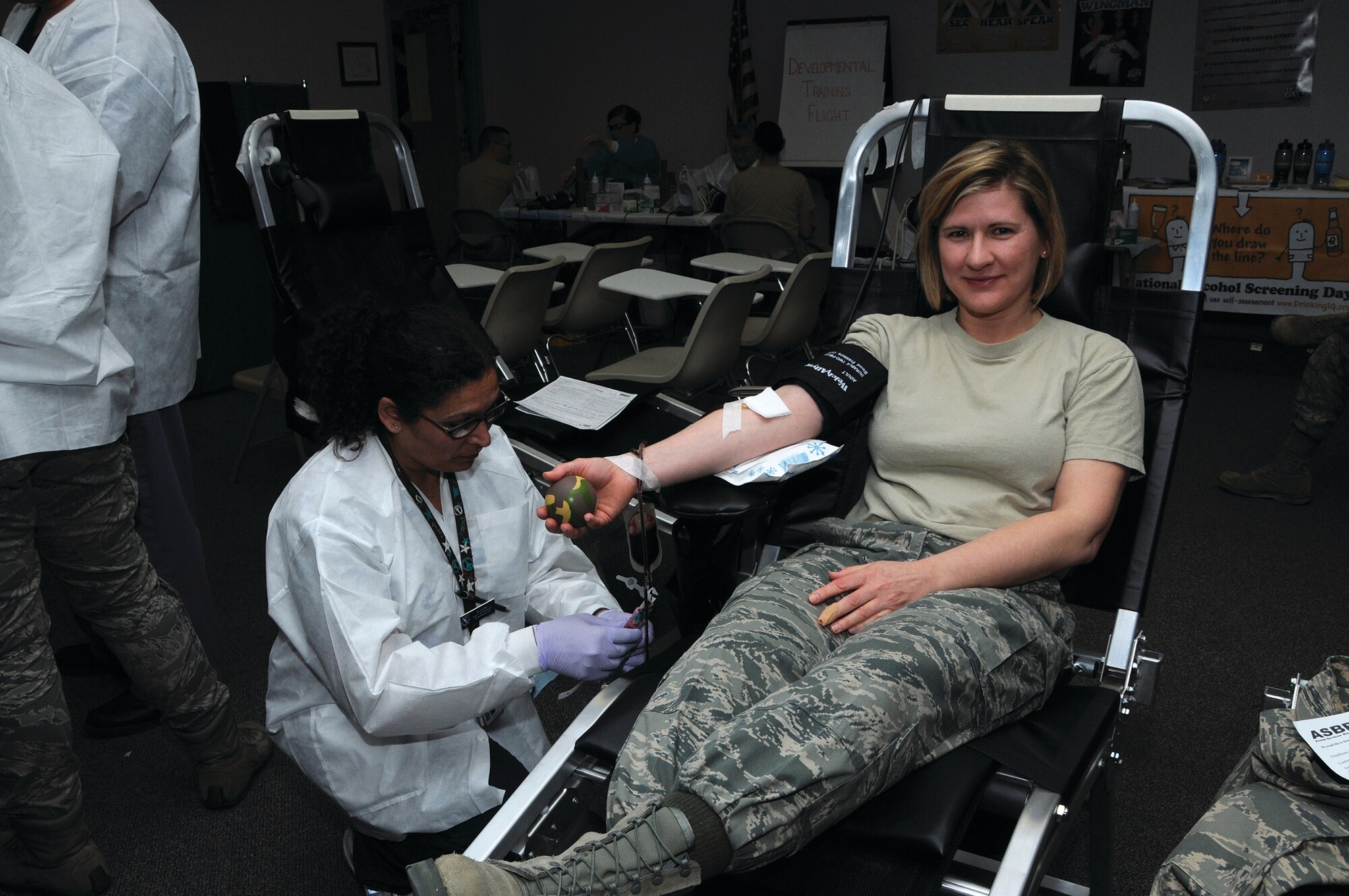 WRIGHT-PATTERSON AIR FORCE BASE, Ohio - Gail Mays, a lab contractor for the 88th Air Base Wing phlembotomist, extracts blood from Staff Sgt. Nicole D. Moore, 445th Aeromedical Staging Squadron medical materiel helper, during the Wright-Patterson Blood Donor Center sponsored blood drive April 6. Wright-Patt is part of the Armed Services Blood Program, the official United States military blood program with all donated blood going to military service members and their families worldwide. (U.S. Air Force photo/Tech. Sgt. Anthony Springer)