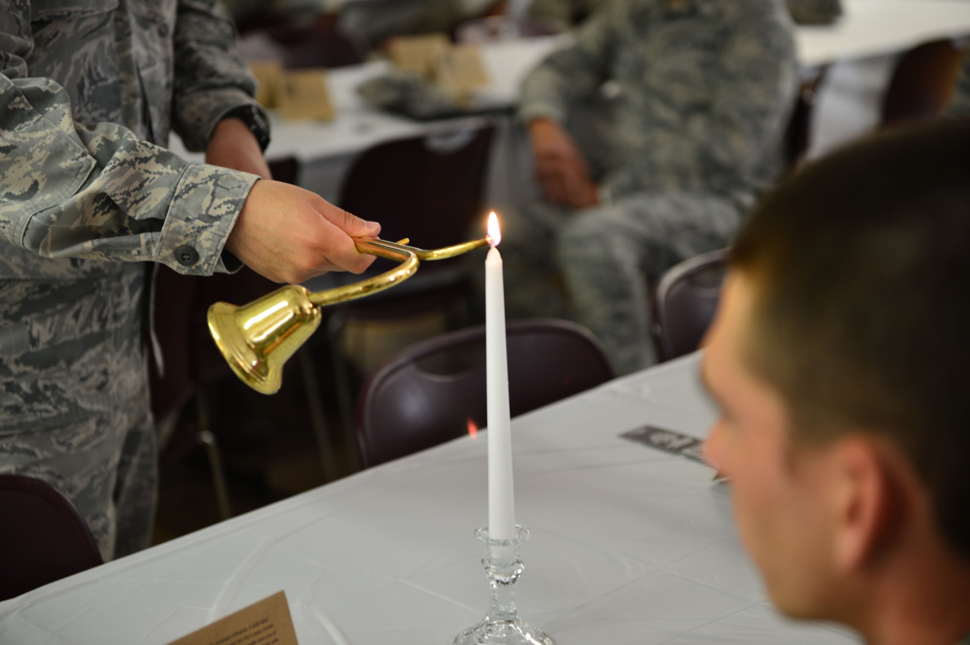 A U.S. Air Commando lights one of many candles dispersed through the room in remembrance of those affected by the Holocaust. Holocaust Remembrance Day is recognized all over the world in the month of April and was held at Cannon Air Force Base, N.M., April 13, 2013. (U.S. Air Force photo/2nd Lt. Angelica Powell). 