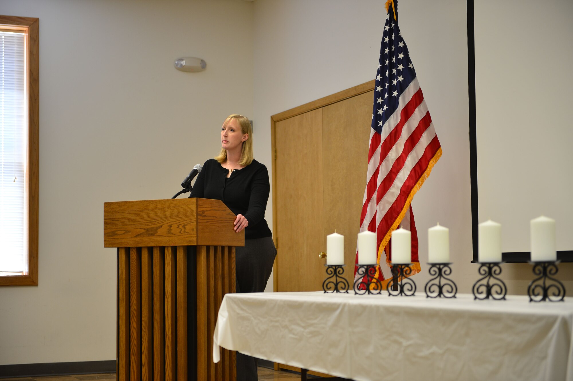 Dr. Valerie McKito, key-note speaker from Eastern New Mexico University, pays tribute to those affected by the Holocaust before the Candle Lighting Ceremony. Holocaust Remembrance Day is recognized all over the world in the month of April and was held at Cannon Air Force Base, N.M., April 13, 2013. (U.S. Air Force photo/2nd Lt. Angelica Powell). 