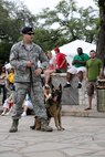 Air Force Staff Sgt. Joshua Hale 802nd Security Forces Squadron military working dog handler, and Kormi, 802nd SFS MDW, demonstrate the capabilities of the K-9 unit during Air Force at the Alamo, one of many San Antonio-wide Fiesta events April 22. (U.S. Air Force photo by Joshua Rodriguez) (U.S. Air Force photo by Joshua Rodriguez) (released)