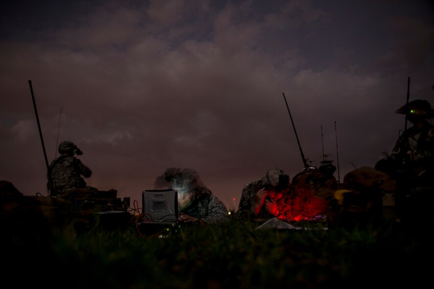 Airmen from the 820th Combat Operations Squadron work in a communications and intelligence focal point on the flightline during a training exercise April 24, 2013, at Moody Air Force Base, Ga. The 820th COS and 824th Base Defense Squadron had total access to the flightline from dusk to dawn to conduct their mission requirements. (U.S. Air Force photo by Staff Sgt. Jamal D. Sutter/Released)  