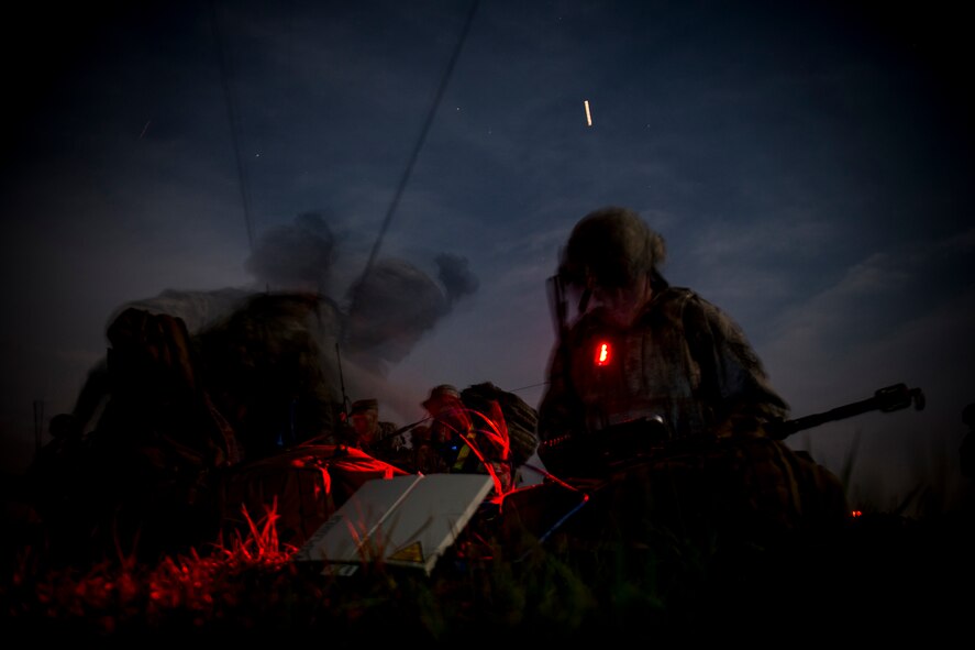 In this long-exposure photo, Airmen from the 820th Combat Operations Squadron work in a communications and intelligence focal point on the flightline during a training exercise April 24, 2013, at Moody Air Force Base, Ga. During the exercise, the 820th COS worked with the 824th Base Defense Squadron to seize and defend the base’s airfield. (U.S. Air Force photo by Staff Sgt. Jamal D. Sutter/Released)