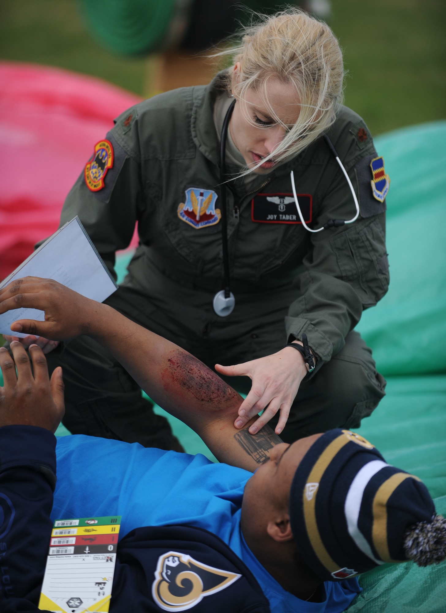 Maj.  Joy Taber, 488th Intelligence Squadron flight surgeon, tends to a simulated casualty during an exercise April 29, 2013, on RAF Mildenhall, England. Taber was one of the emergency medical personnel who responded to the exercise. [(Editor’s note: This image is from an exercise and does not depict any real world event.)(U.S. Air Force photo by Airman 1st Class Preston Webb/Released)]