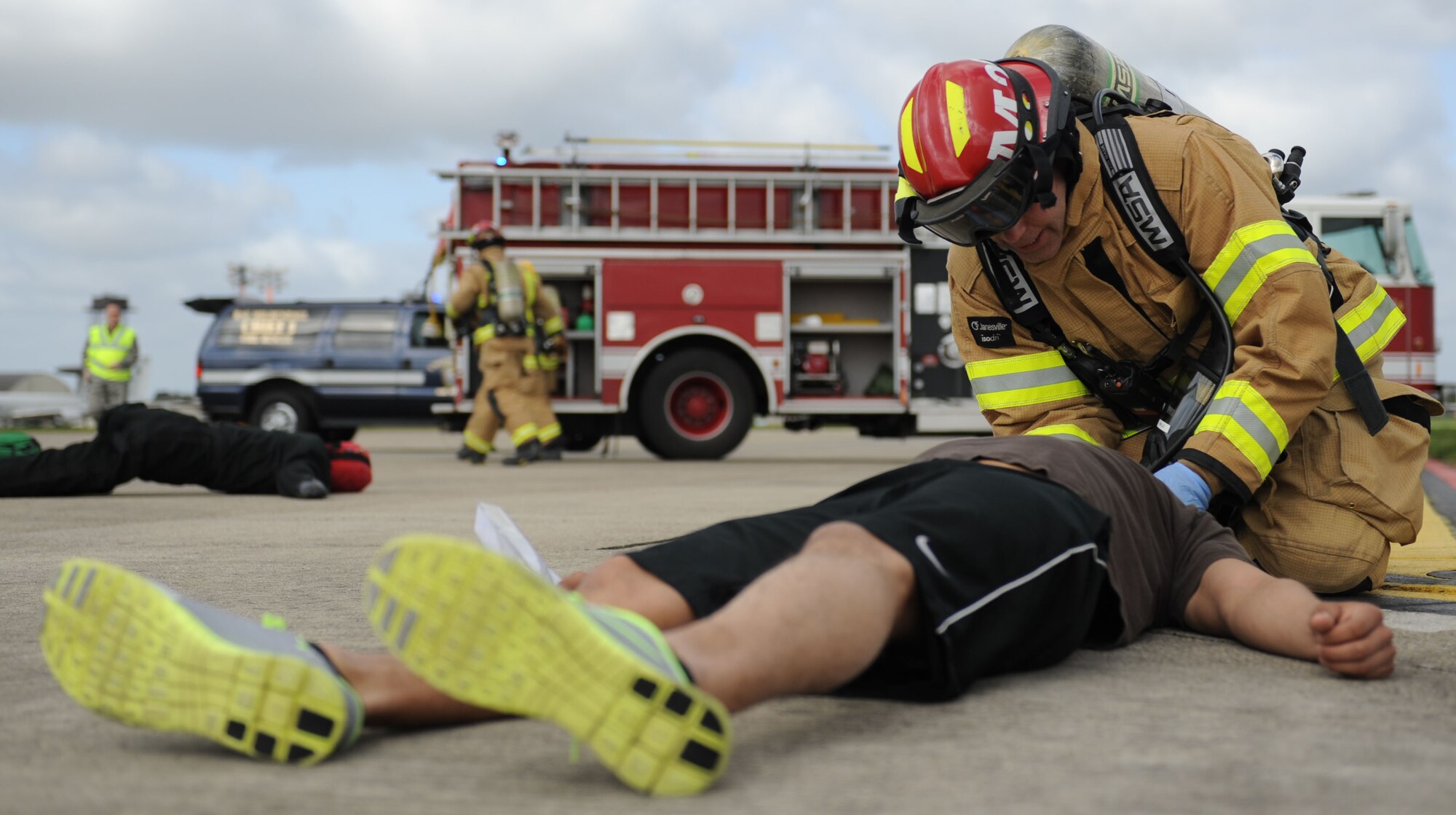 A firefighter with the 100th Civil Engineer Squadron stabilizes the neck of a simulated casualty during an exercise April 29, 2013 on RAF Mildenhall, England. The casualty was “injured” during a hard landing caused when the landing gear of a KC-135 Stratotanker “failed”. [(Editor’s note: This image is from an exercise and does not depict any real world event.)(U.S. Air Force photo by Airman 1st Class Preston Webb/Released)]
