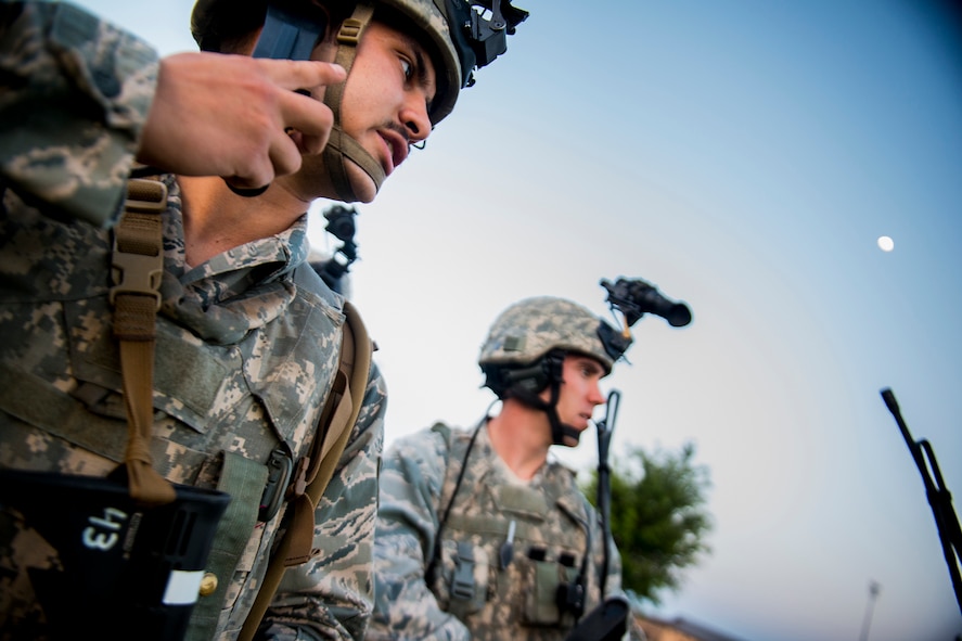 U.S. Air Force Staff Sgt. Dylan Vankerckhoven (left) and Capt. Brandon McKinnon, both of the 820th Combat Operations Squadron, test their communications equipment before a training mission April 22, 2013, at Moody Air Force Base, Ga. The 820th COS teamed with the 824th Base Defense Squadron for a two-day training mission where they performed tasks during late hours of the night. (U.S. Air Force photo by Staff Sgt. Jamal D. Sutter/Released) 