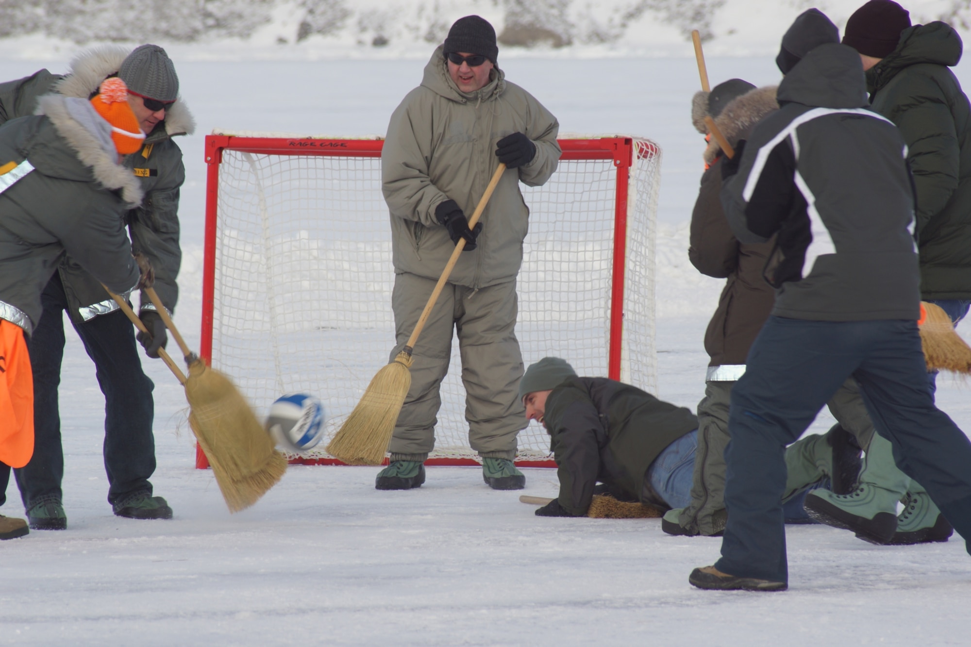 The 821st Support Squadron slides into action during the Mukluk Hockey competition March 30. Thule Air Base celebrated Armed Forces Day March 30-31 by inviting native Greenlandic residents to the base, some of whom traveled up to three days across the extremely cold environment by dog sled to attend the celebration. (U.S. Air Force photo/Tech. Sgt. Jeffrey Mikell)