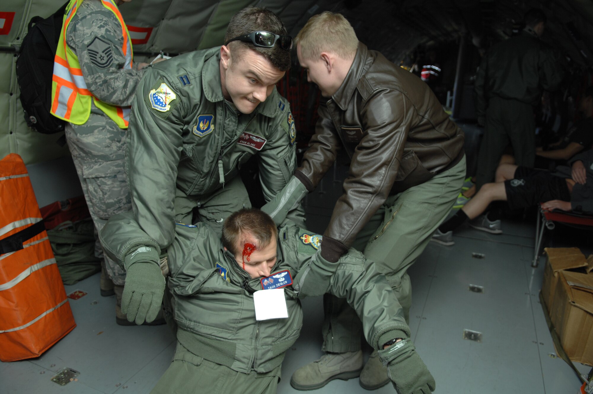 During an exercise, Service members on board a “crashed” KC-135 Stratotanker drag a “casualty” from the plane April 29, 2013, on RAF Mildenhall, England. The exercise created a scenario in which KC-135 malfunctioned while landing, causing it to “veer off-course” and an engine to “catch on fire.” [(Editor’s note: This image is from an exercise and does not depict any real world event.)(U.S. Air Force photo by Airman 1st Class Dillon Johnston/Released)]