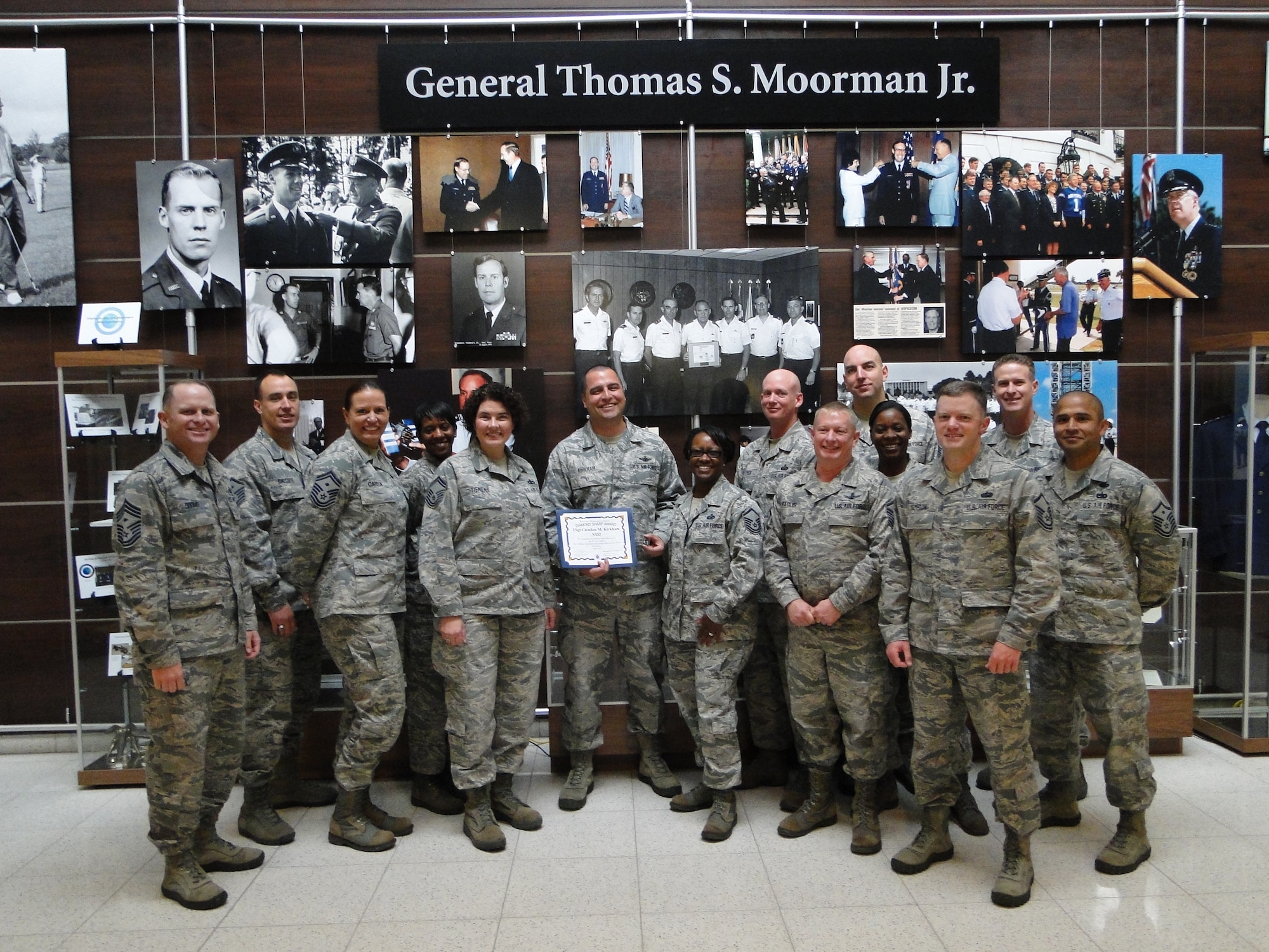 PETERSON AIR FORCE BASE, Colo. -- Tech. Sgt. Glen Kirkham (center) was awarded the Team Peterson First Sergeants Council Diamond Sharp Airman. Kirkham is the National Security Space Institute mission support NCOIC. He is an active vice president for the multi-unit booster club and volunteers to brief first-term Airmen on his deployment experience as part of the First Term Airmen Center curriculum. He also coaches a youth soccer team and recently took over the base-wide World War II veterans outreach program. The Sharp Warrior Award is awarded each month in recognition of Team Petersons’ best. Any first sergeant or senior NCO serving as a first sergeant who observes outstanding performance may nominate someone for the award to the first sergeants council. (U.S. Air Force photo)