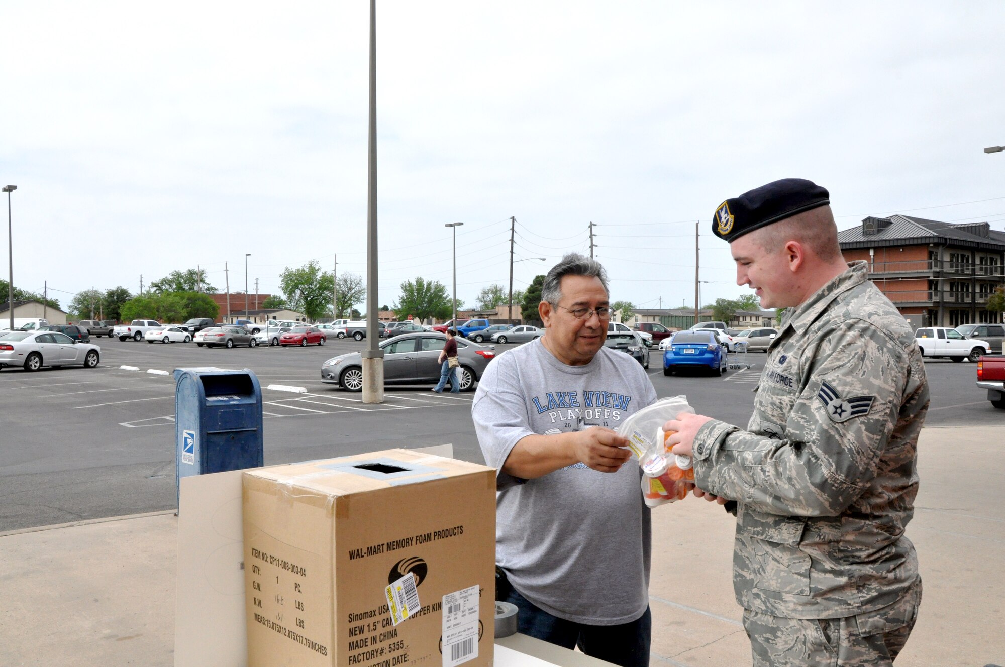 GOODFELLOW AIR FORCE BASE, Texas—Senior Airman Jeremy Dugan, 17th Security Forces Squadron patrolman, receives unused prescription drugs from Manuel Guerra, Air Force retiree, during the Drug Take-Back event in front of the Base Exchange, April 27. The 17th Security Forces Squadron and 17th Medical Group work together about twice a year to sponsor the event, which gives Team Goodfellow members a chance to dispose of unused drugs in a legal and environmentally conscious manner. (U.S. Air Force photo/Airman Jessica Keith)  