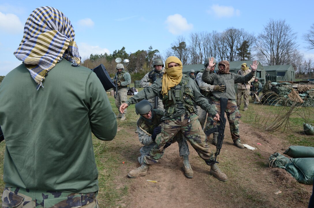 SPANGDAHLEM AIR BASE, Germany – Airmen from the 606th Air Control Squadron search opposing forces (OPFOR) during a combat readiness training course April 20, 2013. The searches are invasive in nature to all a thorough search of a detainee for any weapons or explosives. (U.S. Air Force photo by Airman 1st Class Kyle Gese/Released)